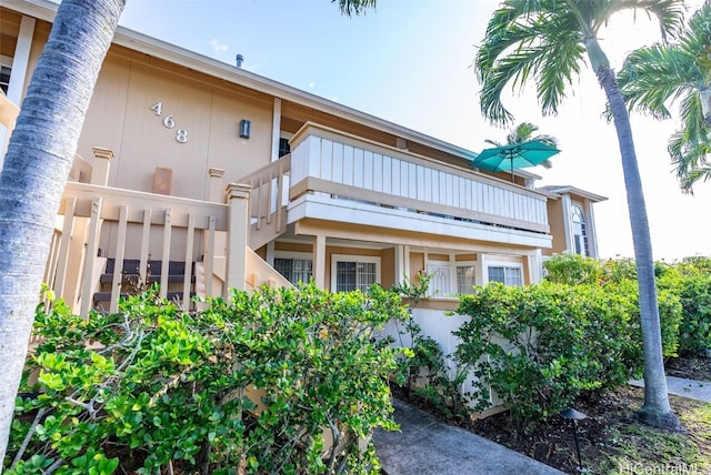 view of side of home featuring a balcony