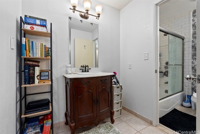 full bathroom with vanity, bath / shower combo with glass door, tile patterned flooring, toilet, and a chandelier