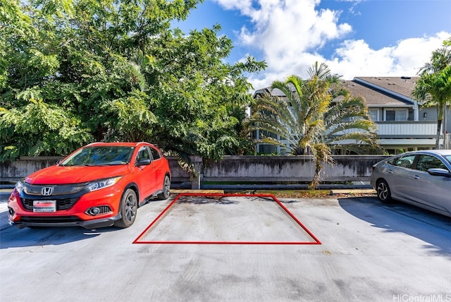 uncovered parking lot featuring fence