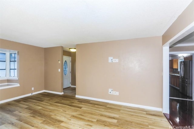 unfurnished room with hardwood / wood-style flooring