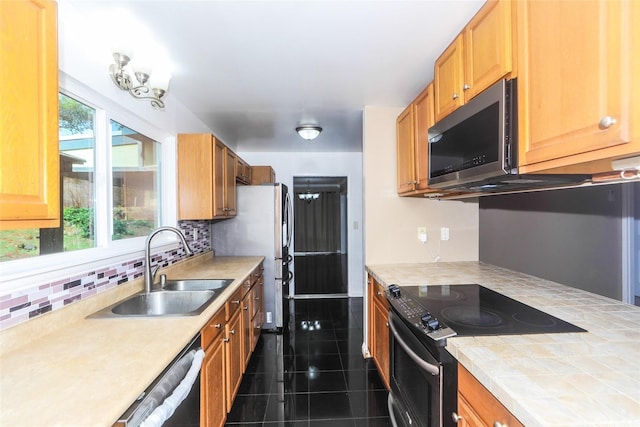 94-15 Kaweo Pl, Mililani, HI 96789 - kitchen with stainless steel appliances, backsplash, dark tile patterned floors, tile counters, and brown cabinets