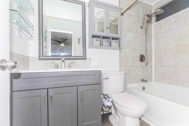 full bathroom featuring vanity, toilet, and tiled shower / bath combo