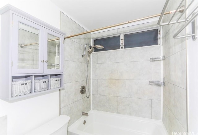 bathroom with toilet and tiled shower / bath