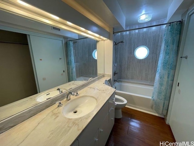 full bathroom featuring toilet, hardwood / wood-style flooring, vanity, and shower / tub combo with curtain