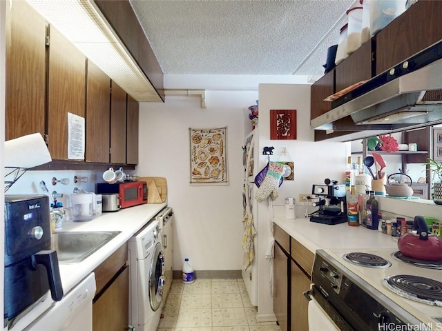 kitchen with white appliances, sink, a textured ceiling, range hood, and washer / clothes dryer