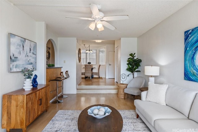 living area featuring ceiling fan and light wood finished floors