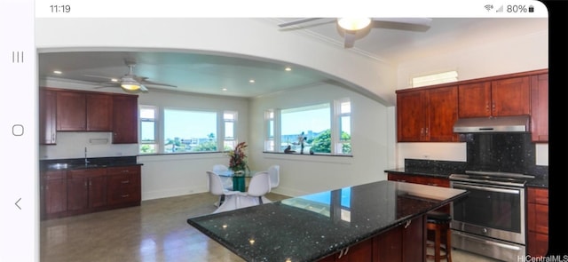 kitchen featuring stainless steel electric range oven, sink, decorative backsplash, dark stone counters, and crown molding