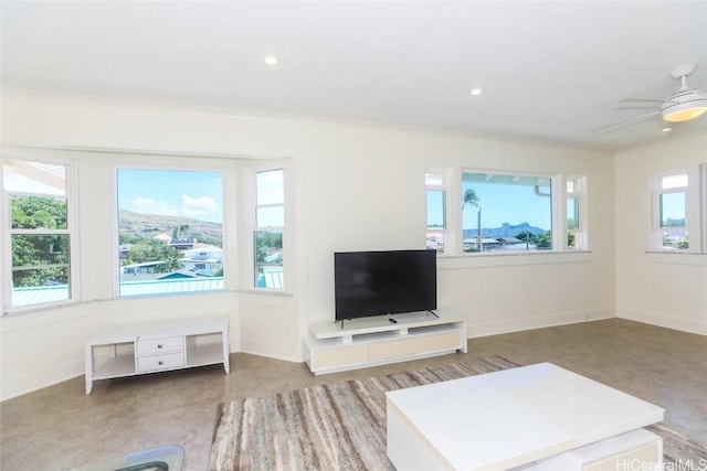 living room featuring plenty of natural light and ceiling fan