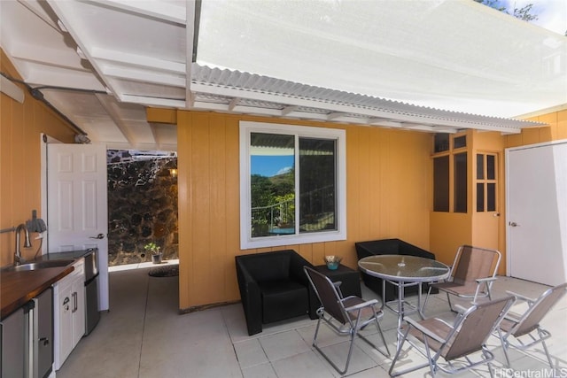 view of patio / terrace featuring outdoor dining space and a sink