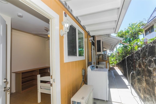 exterior space featuring laundry area, ceiling fan, and separate washer and dryer