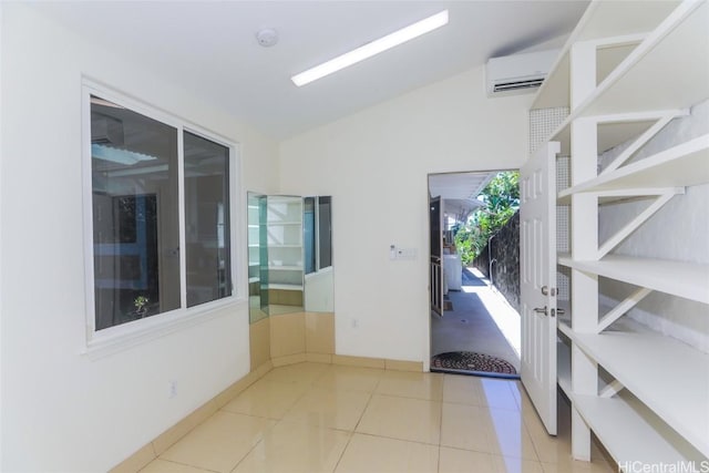 interior space featuring vaulted ceiling and an AC wall unit