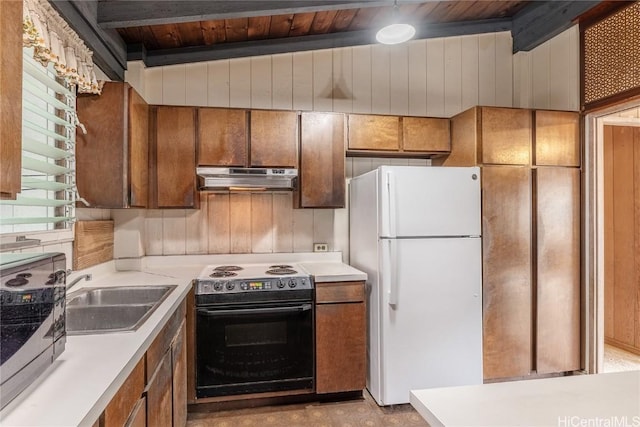 kitchen with white refrigerator, black electric range oven, wood walls, and sink