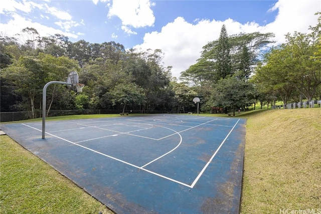 view of sport court featuring a lawn