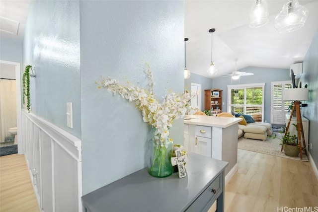 bathroom featuring hardwood / wood-style floors, toilet, ceiling fan, and lofted ceiling