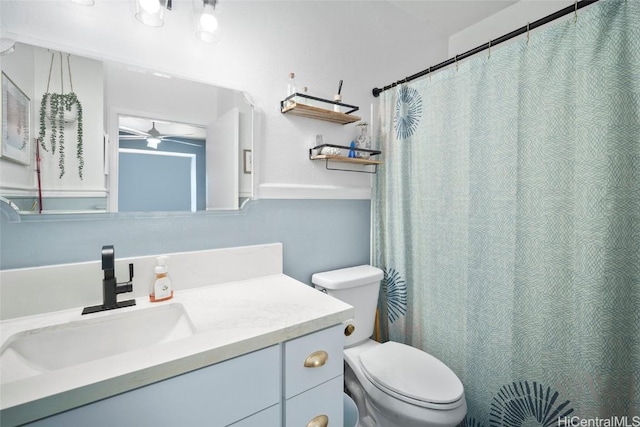 bathroom featuring vanity, ceiling fan, and toilet