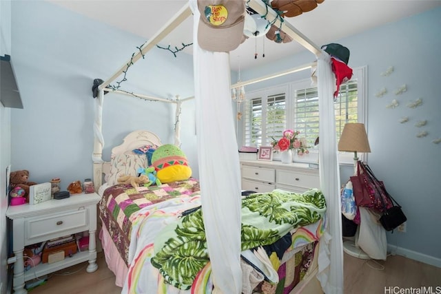 bedroom with hardwood / wood-style flooring and ceiling fan