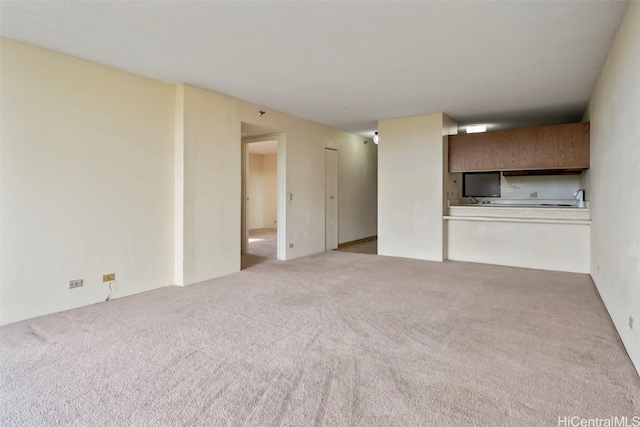 unfurnished living room featuring light colored carpet