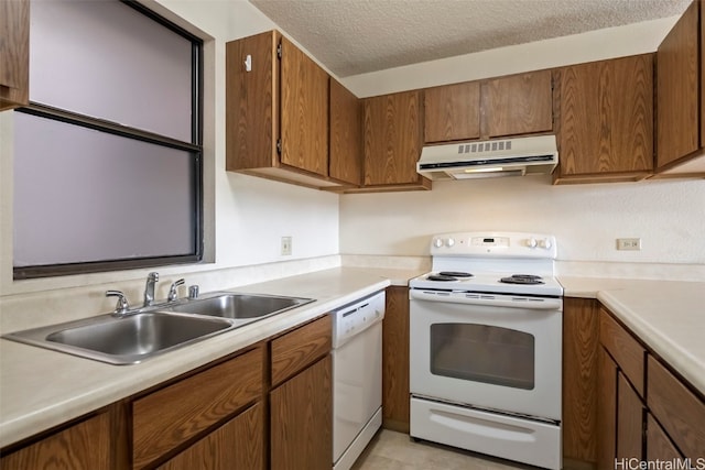 kitchen with sink, white appliances, and a textured ceiling