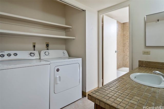 washroom featuring separate washer and dryer and sink