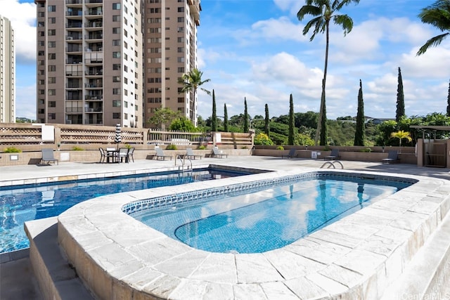 view of pool featuring a community hot tub and a patio