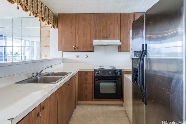 kitchen featuring stainless steel fridge, black electric range oven, sink, and a textured ceiling