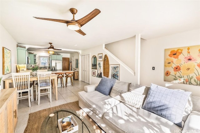 tiled living room featuring ceiling fan