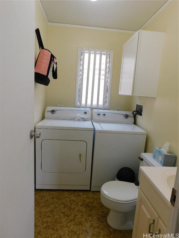 bathroom with washer and clothes dryer, vanity, crown molding, and toilet