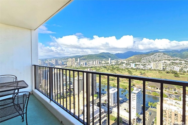 balcony with a water and mountain view