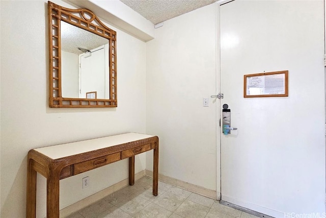 doorway with a textured ceiling