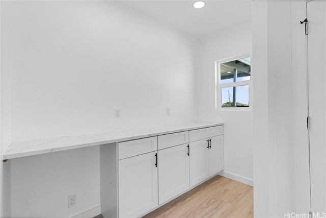 laundry area with light wood-type flooring