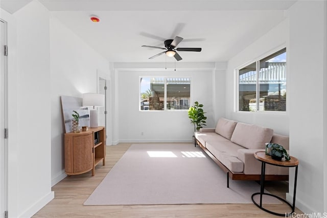 living room with ceiling fan and light hardwood / wood-style floors