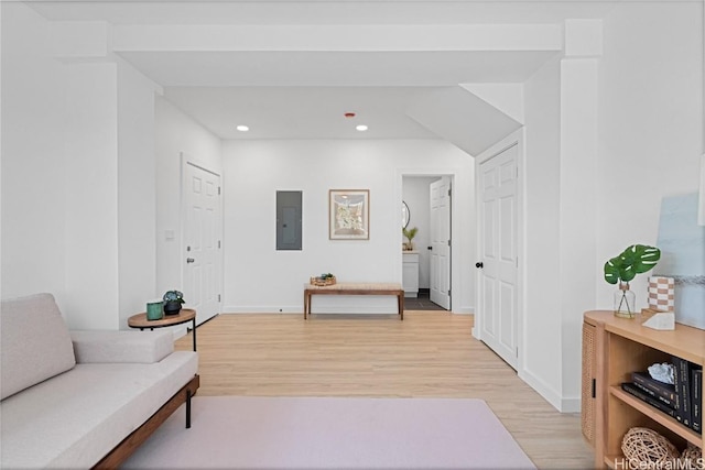 sitting room featuring electric panel and light hardwood / wood-style floors