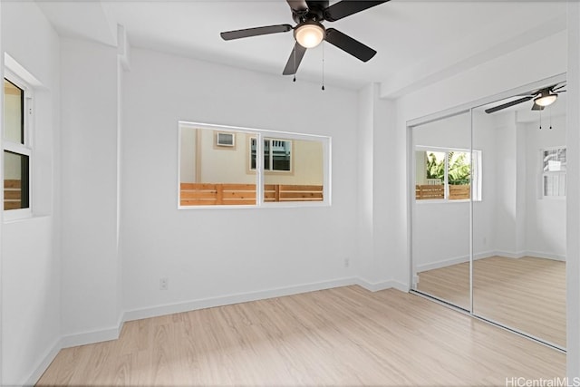 unfurnished bedroom with ceiling fan, a closet, and light hardwood / wood-style floors