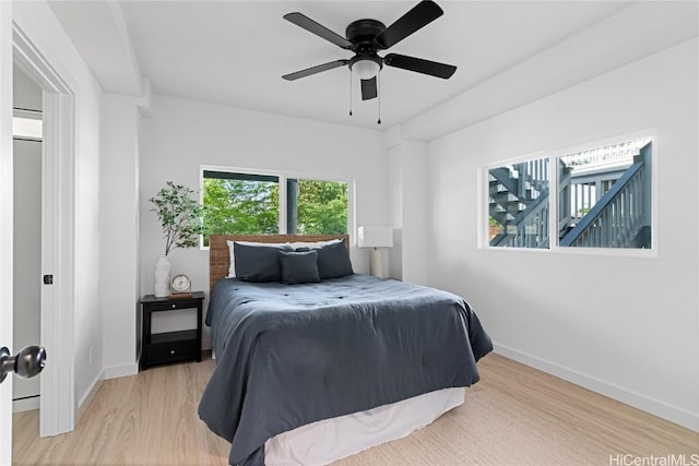 bedroom with ceiling fan and light hardwood / wood-style flooring