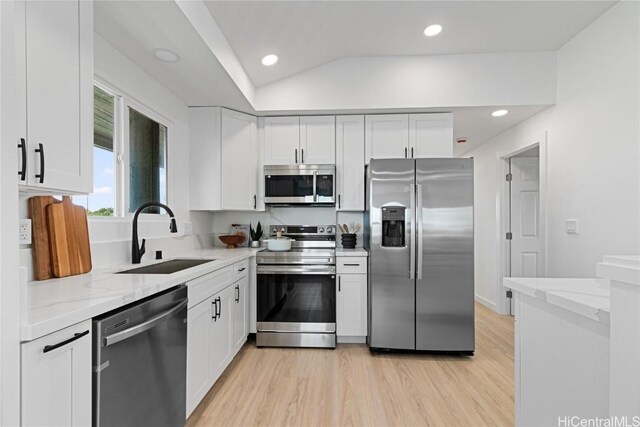 kitchen featuring white cabinets, stainless steel appliances, and sink