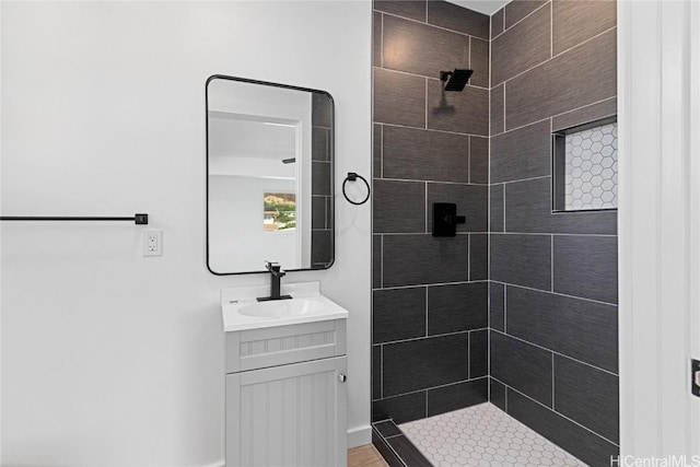 bathroom featuring vanity and tiled shower