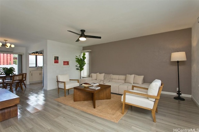 living room featuring ceiling fan and light wood-type flooring