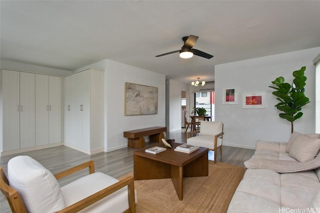 living room with ceiling fan and light wood-type flooring