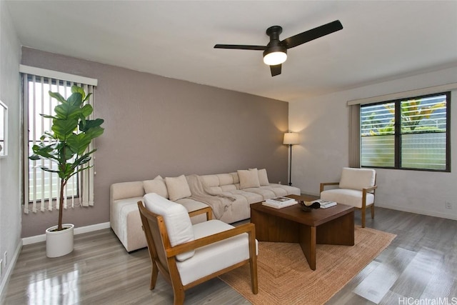 living room featuring light hardwood / wood-style floors and ceiling fan