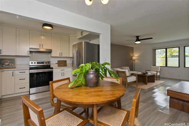 kitchen featuring white cabinets, ceiling fan, stainless steel appliances, and light hardwood / wood-style flooring