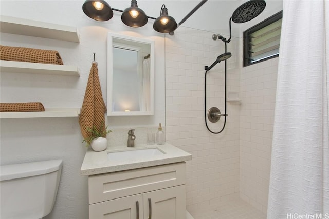 bathroom with toilet, vanity, and a shower with shower curtain