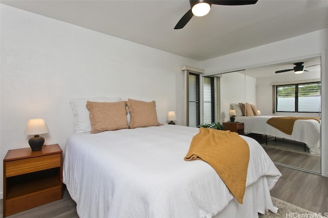 bedroom featuring ceiling fan, a closet, and hardwood / wood-style floors