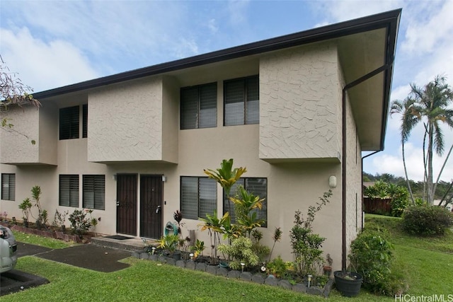 rear view of property with a yard