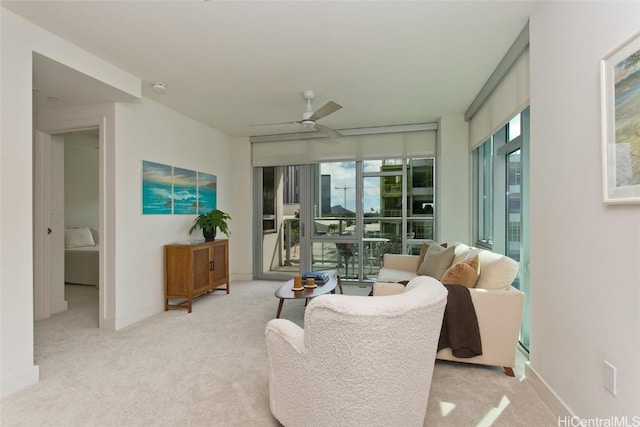 carpeted living room with ceiling fan