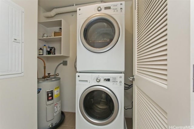 clothes washing area with stacked washing maching and dryer and water heater