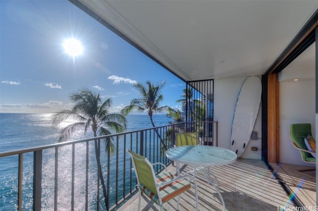 balcony featuring a water view and a view of the beach