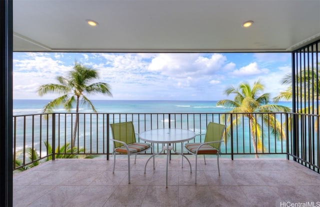 balcony featuring a beach view and a water view