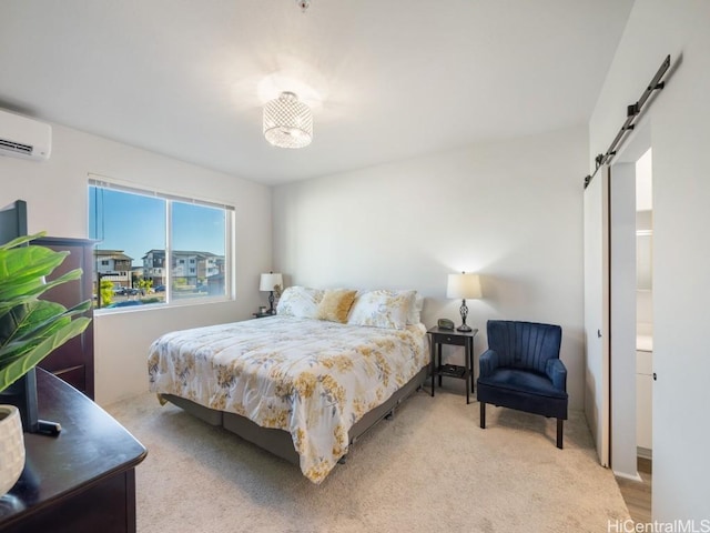 bedroom with a wall mounted air conditioner and a barn door