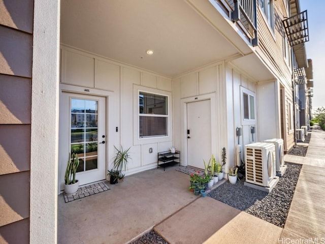 property entrance with ac unit and a patio