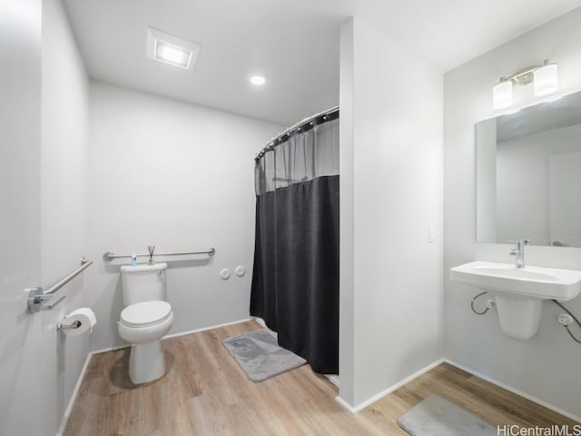 bathroom with a shower with curtain, toilet, and wood-type flooring